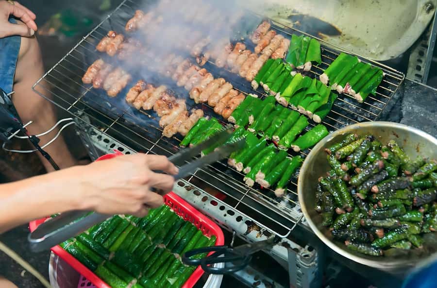 Saigon: Best Price Authentic Walking Street Food Tour - Bánh khọt, herbs, and the proper way to eat