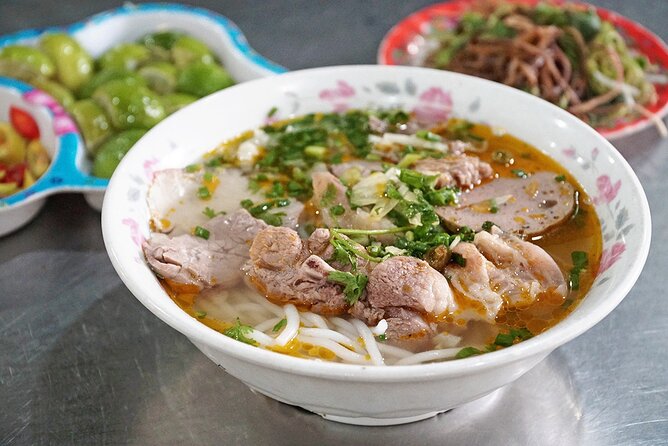 The Unique Ao Dai Street Food Tour By Scooter - Bun bo Hue in a historic apartment complex
